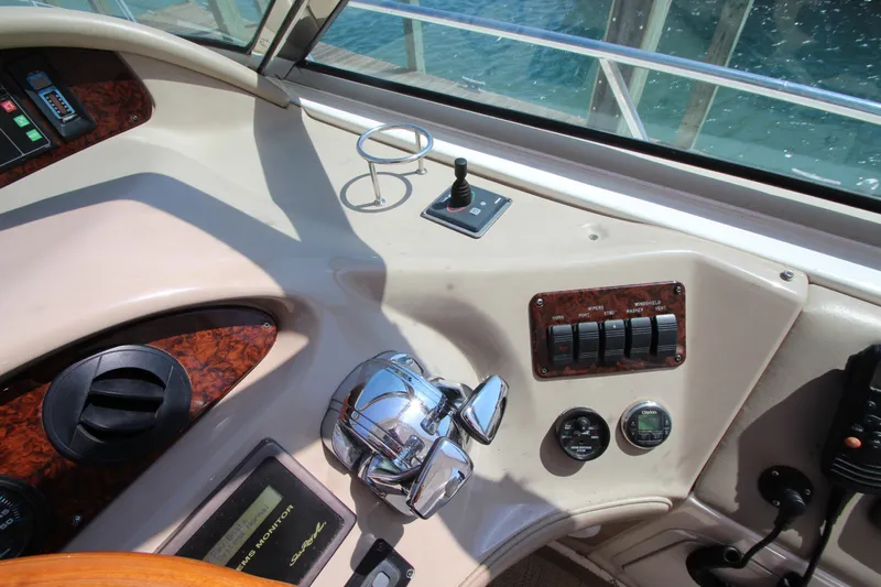  Yacht Photos Pics Helm controls of a 2003 Sea Ray 550 Sundancer yacht, featuring polished chrome and wood accents.