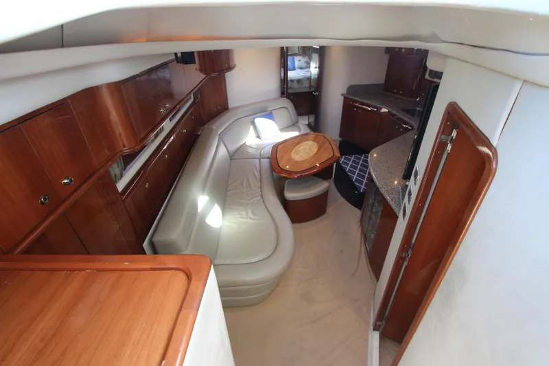  Yacht Photos Pics Luxurious interior of 2003 Sea Ray 550 Sundancer yacht with leather seating and wooden cabinetry.