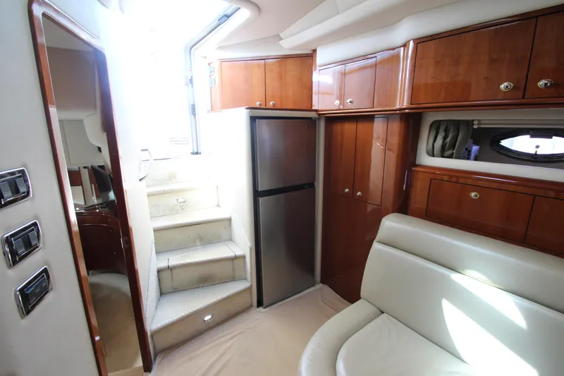  Yacht Photos Pics Interior of 2003 Sea Ray 550 Sundancer yacht with stairs, cabinets, and seating area.