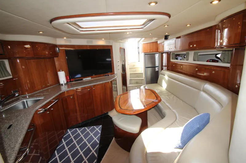  Yacht Photos Pics Luxurious interior of 2003 Sea Ray 550 Sundancer yacht with modern kitchen and seating area.