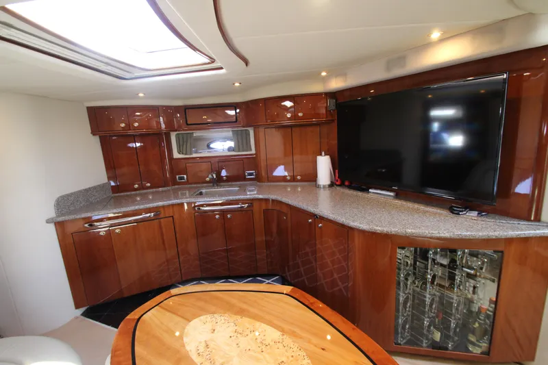  Yacht Photos Pics Luxurious interior of 2003 Sea Ray 550 Sundancer yacht with modern kitchen and entertainment area.