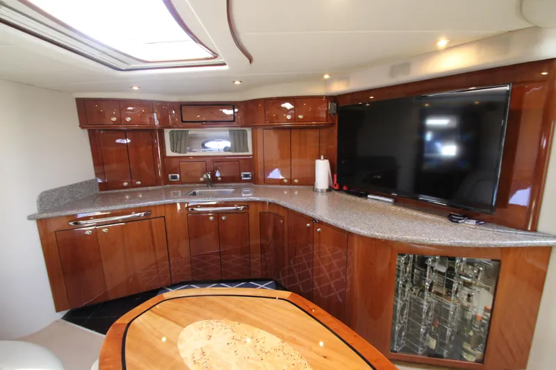  Yacht Photos Pics Luxurious interior of 2003 Sea Ray 550 Sundancer yacht with modern kitchen and entertainment area.