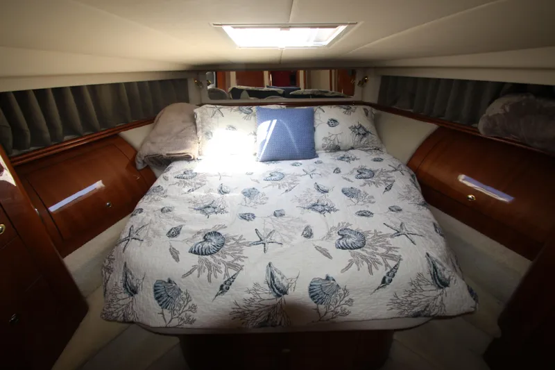  Yacht Photos Pics Luxurious cabin interior of 2003 Sea Ray 550 Sundancer with nautical-themed bedding.