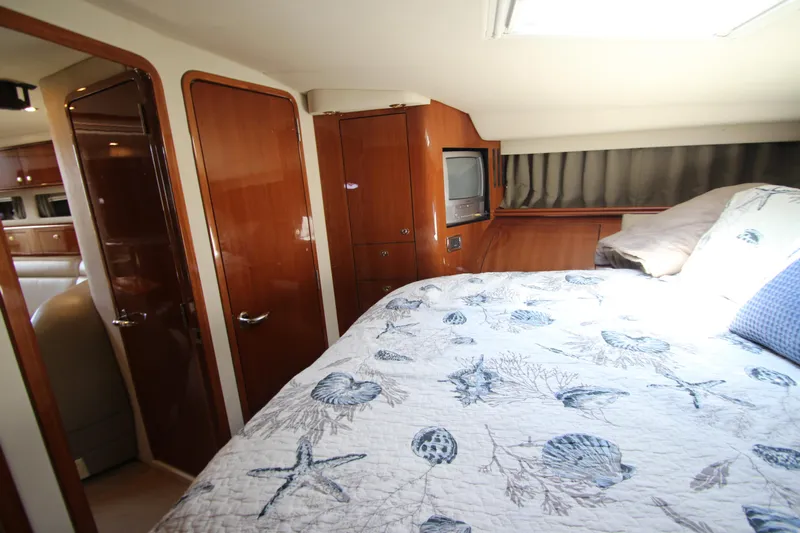  Yacht Photos Pics Luxurious cabin interior of 2003 Sea Ray 550 Sundancer with nautical-themed bedding.