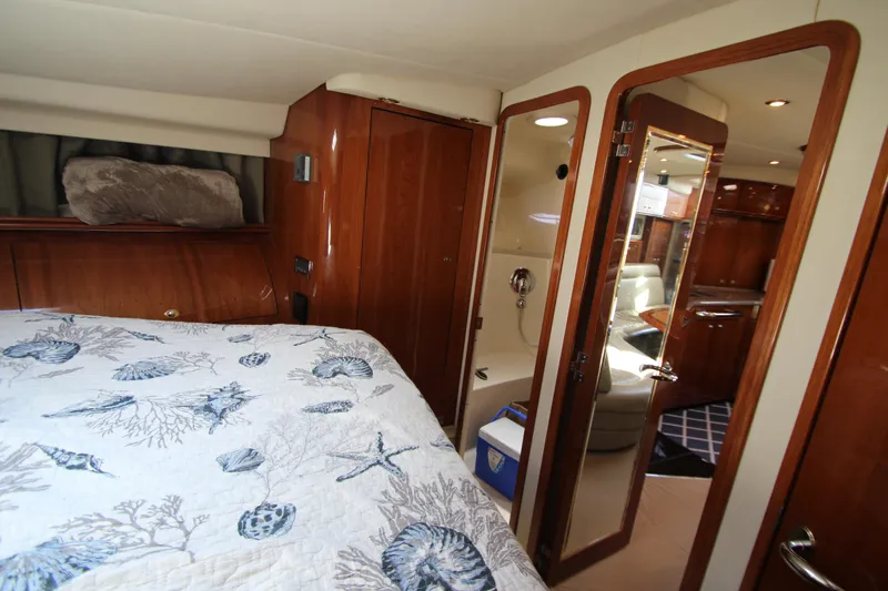  Yacht Photos Pics Interior of 2003 Sea Ray 550 Sundancer yacht with cozy bedroom and elegant wood finishes.