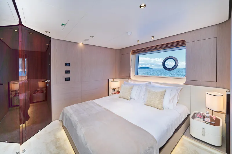  Yacht Photos Pics Luxurious bedroom interior of 2024 Azimut Grande 27 METRI yacht with ocean view.