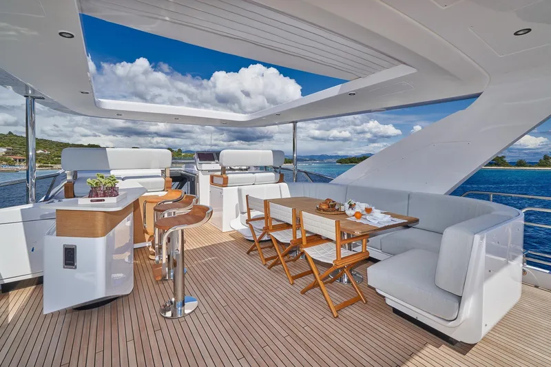  Yacht Photos Pics Luxurious deck of 2024 Azimut Grande 27 METRI yacht with seating and dining area.