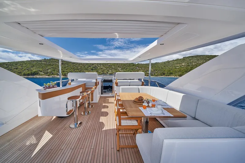  Yacht Photos Pics Luxurious deck of 2024 Azimut Grande 27 METRI yacht with dining area and bar.
