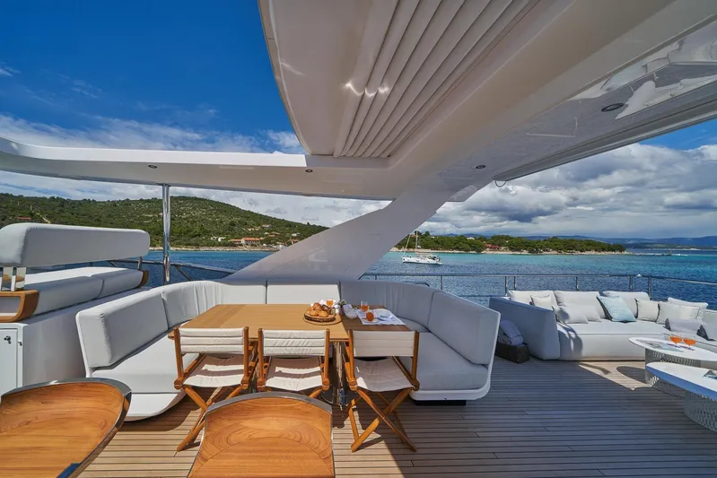  Yacht Photos Pics Luxurious deck of 2024 Azimut Grande 27 METRI yacht with elegant seating and ocean view.