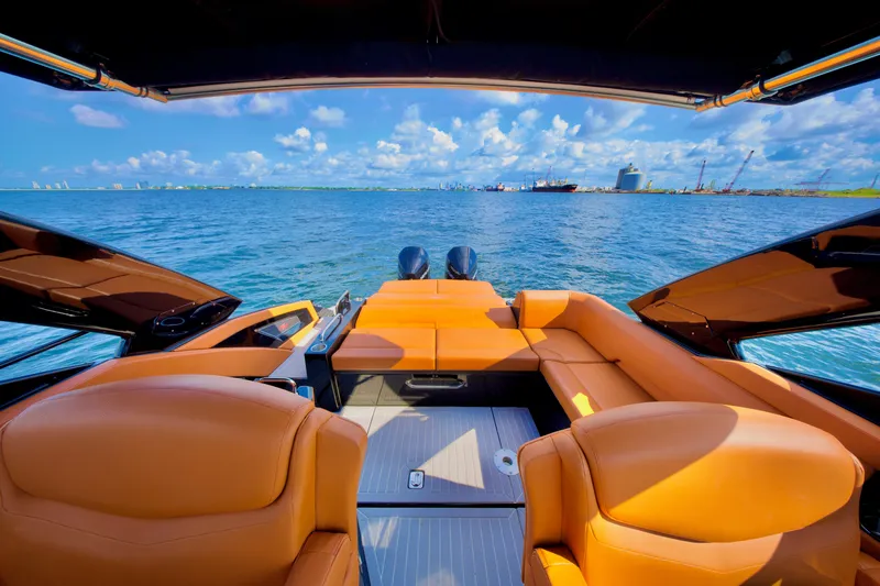  Yacht Photos Pics 2022 Cruisers Yachts 338 South Beach Edition Bow Rider on open water, luxurious seating, clear sky.