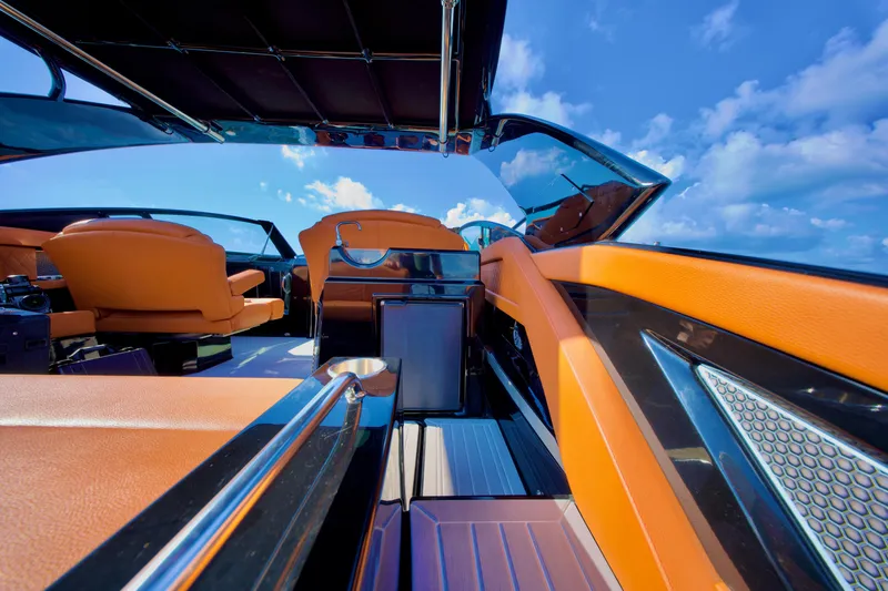  Yacht Photos Pics 2022 Cruisers Yachts 338 South Beach Edition Bow Rider interior with orange seating and blue sky.