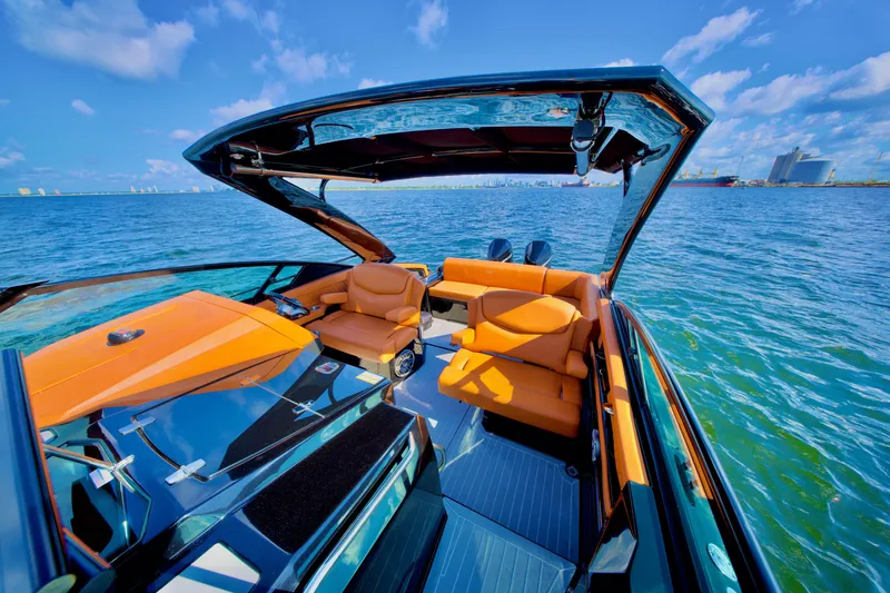  Yacht Photos Pics 2022 Cruisers Yachts 338 South Beach Edition Bow Rider on open water, featuring luxurious orange seating.