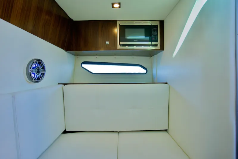  Yacht Photos Pics Interior of 2022 Cruisers Yachts 338 South Beach Edition, featuring a cozy cabin with a microwave.