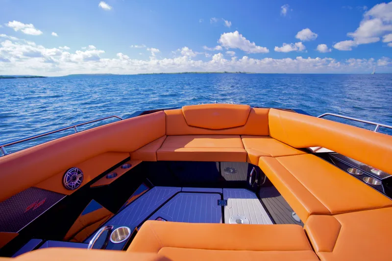  Yacht Photos Pics 2022 Cruisers Yachts 338 South Beach Edition Bow Rider on open water, featuring orange seating.