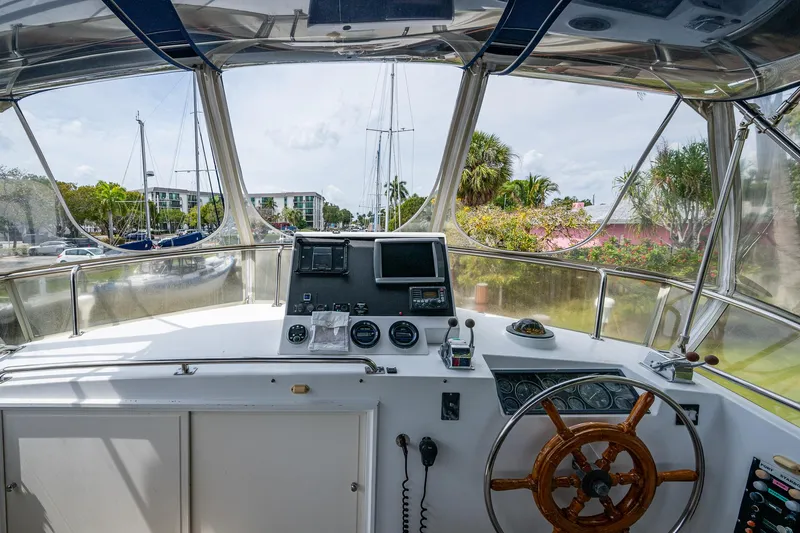 Grande Jete Yacht Photos Pics Helm of 1990 Grand Banks 46 Classic yacht with navigation equipment and wooden steering wheel.