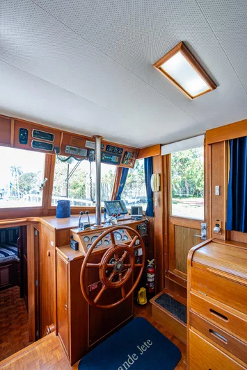 Grande Jete Yacht Photos Pics 1990 Grand Banks 46 Classic yacht interior with wooden helm and navigation equipment.