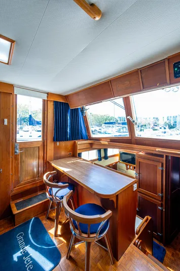 Grande Jete Yacht Photos Pics 1990 Grand Banks 46 Classic yacht interior with wooden furnishings and large windows.