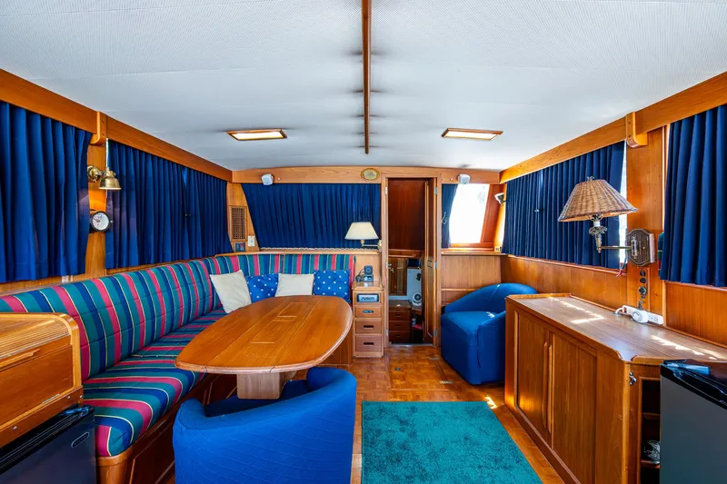 Grande Jete Yacht Photos Pics Interior of 1990 Grand Banks 46 Classic yacht with wood finish and blue accents.