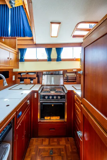 Grande Jete Yacht Photos Pics Interior of 1990 Grand Banks 46 Classic yacht, featuring a well-equipped wooden kitchen.