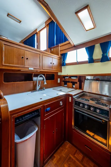 Grande Jete Yacht Photos Pics 1990 Grand Banks 46 Classic yacht kitchen with wood cabinetry and modern appliances.
