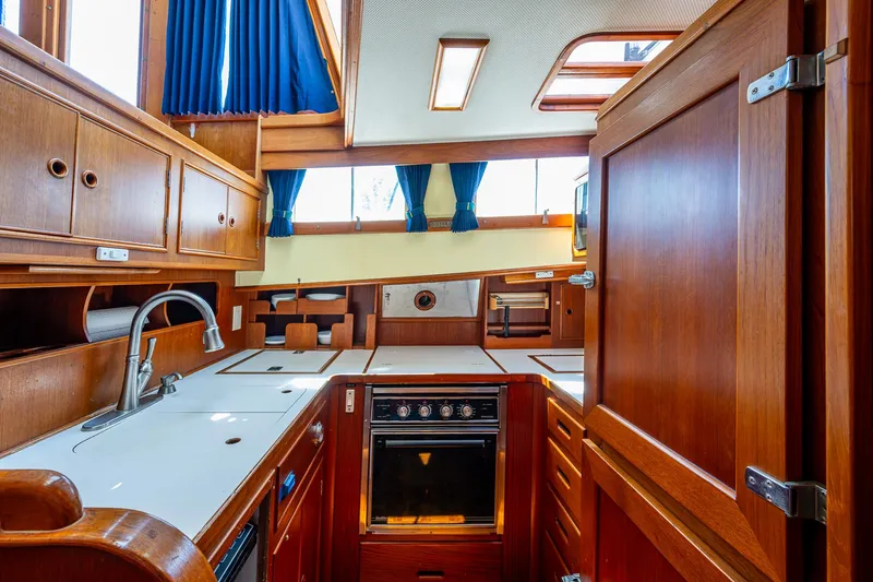 Grande Jete Yacht Photos Pics Interior of 1990 Grand Banks 46 Classic yacht, featuring a well-equipped wooden kitchen.