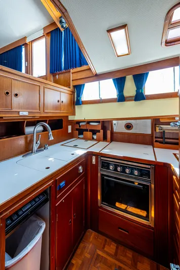 Grande Jete Yacht Photos Pics 1990 Grand Banks 46 Classic yacht kitchen with wood cabinetry and modern appliances.