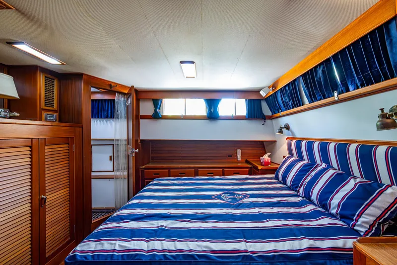 Grande Jete Yacht Photos Pics Luxurious bedroom interior of 1990 Grand Banks 46 Classic yacht with striped bedding.