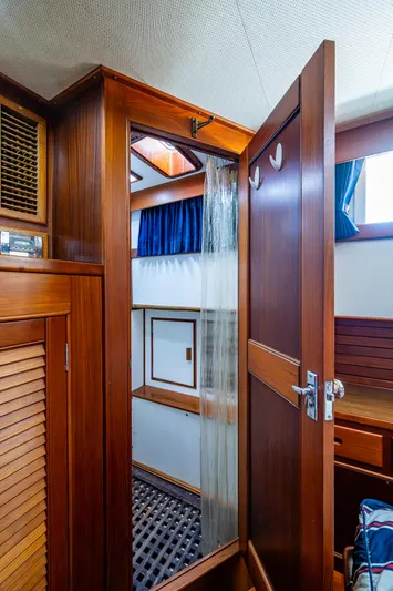 Grande Jete Yacht Photos Pics Interior of 1990 Grand Banks 46 Classic yacht, featuring wooden cabinetry and a shower area.