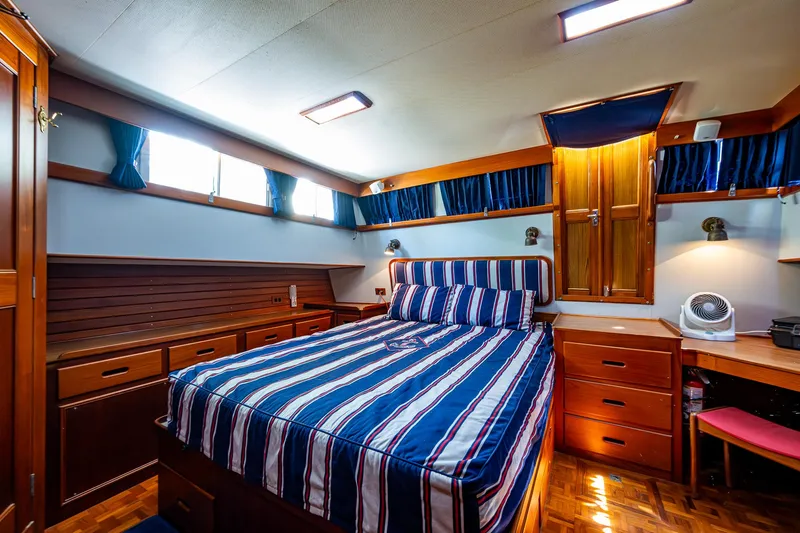 Grande Jete Yacht Photos Pics Luxurious cabin interior of 1990 Grand Banks 46 Classic yacht with striped bedding.