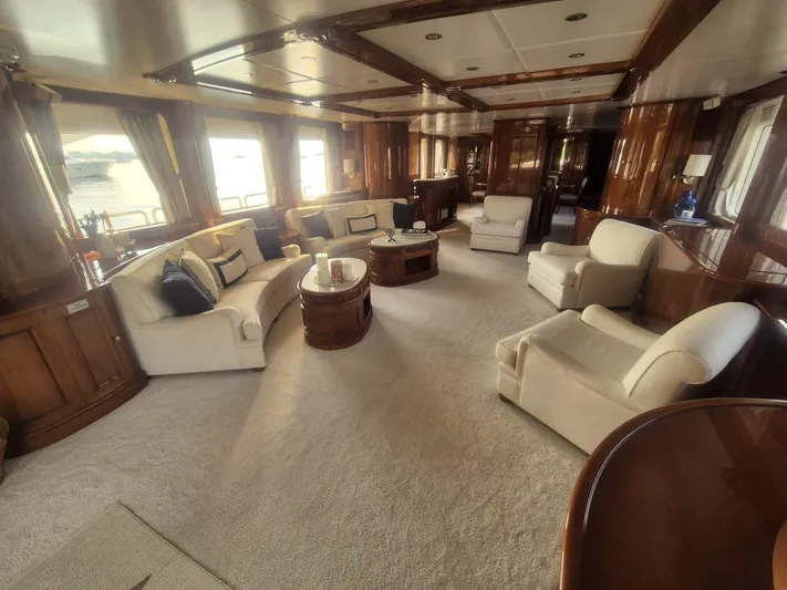 Frienship Yacht Photos Pics Luxurious interior of a 2000 Benetti Classic 115 yacht with elegant seating and wood finishes.