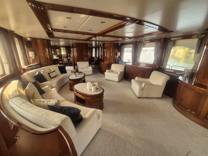 Frienship Yacht Photos Pics Luxurious interior of a 2000 Benetti Classic 115 yacht with elegant seating and wood finishes.