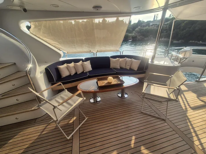 Frienship Yacht Photos Pics Luxurious Benetti Classic 115 yacht deck with elegant seating, 2000 model.