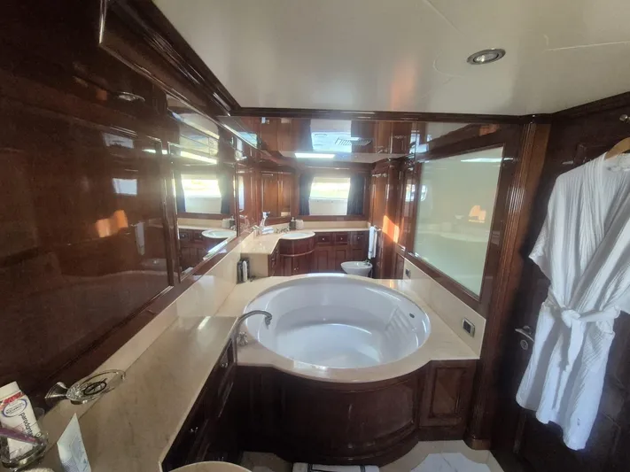 Frienship Yacht Photos Pics Luxurious bathroom on 2000 Benetti Classic 115 yacht with elegant wood paneling and jacuzzi tub.