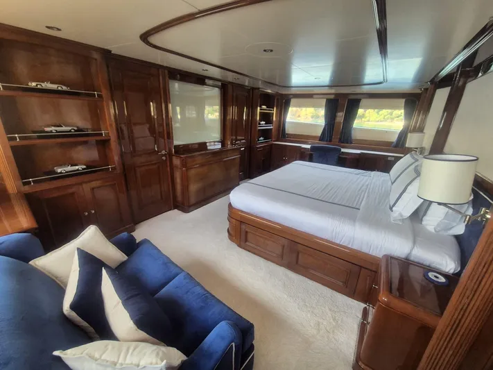 Frienship Yacht Photos Pics Luxurious bedroom interior of 2000 Benetti Classic 115 yacht with elegant wood finishes.