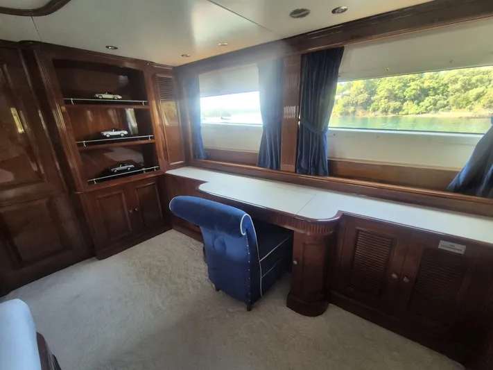 Frienship Yacht Photos Pics Luxurious interior of 2000 Benetti Classic 115 yacht with elegant woodwork and scenic window view.