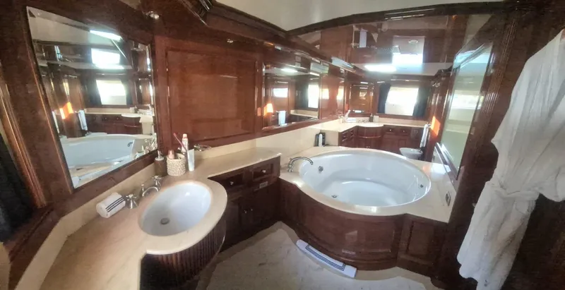 Frienship Yacht Photos Pics Luxurious bathroom on 2000 Benetti Classic 115 yacht with wood accents and jacuzzi tub.