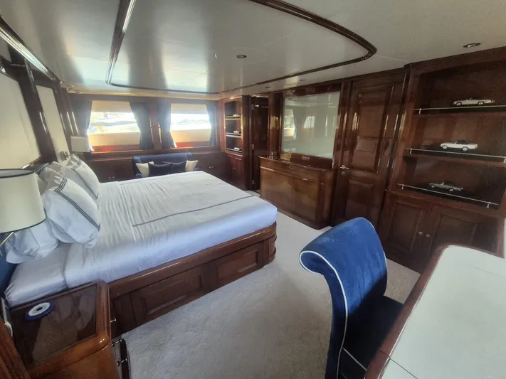 Frienship Yacht Photos Pics Luxurious bedroom interior of 2000 Benetti Classic 115 yacht with elegant wood finishes.