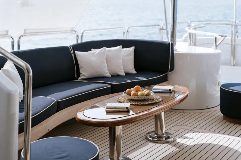 Frienship Yacht Photos Pics Luxurious Benetti Classic 115 yacht deck with elegant seating, fruit bowl, and ocean view.