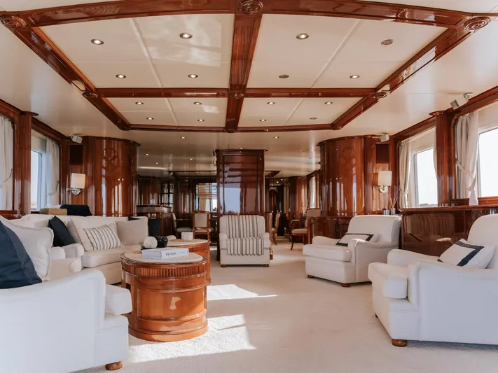 Frienship Yacht Photos Pics Luxurious interior of 2000 Benetti Classic 115 yacht with elegant wood finishes and plush seating.