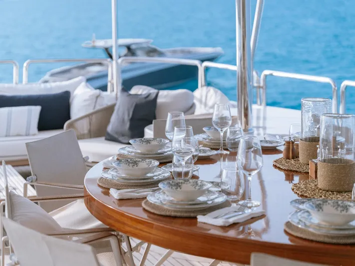 Frienship Yacht Photos Pics Elegant dining setup on Benetti Classic 115 yacht, 2000 model, with ocean view.