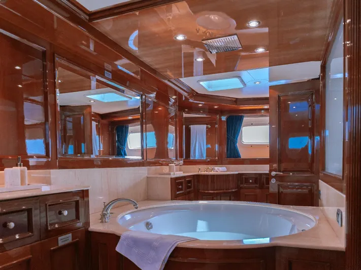 Frienship Yacht Photos Pics Luxurious bathroom interior on a 2000 Benetti Classic 115 yacht, featuring elegant wood finishes.