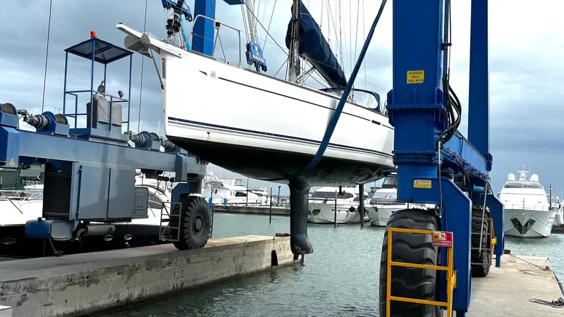 4746 Yacht Photos Pics Sailboat Dufour 44 Performance 2006 lifted by crane at marina.