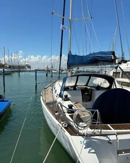 4746 Yacht Photos Pics 2006 Dufour 44 Performance sailboat docked in a marina under a clear blue sky.