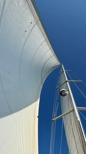 4746 Yacht Photos Pics Sailing yacht Dufour 44 Performance 2006 with sails against clear blue sky.