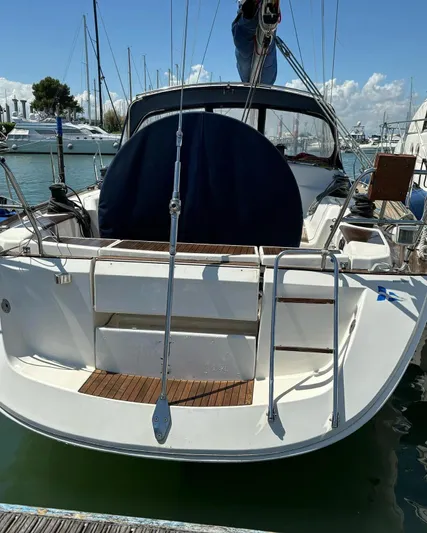 4746 Yacht Photos Pics 2006 Dufour 44 Performance sailboat docked, rear view with ladder and cockpit cover.