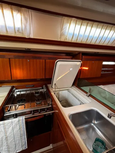 4746 Yacht Photos Pics 2006 Dufour 44 Performance yacht kitchen with stove, sink, and storage.