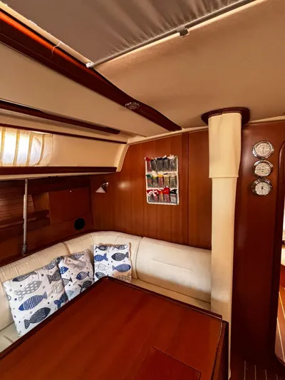 4746 Yacht Photos Pics Interior of 2006 Dufour 44 Performance yacht with cozy seating and nautical decor.