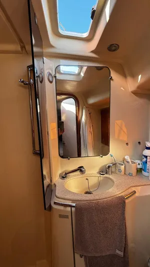 4746 Yacht Photos Pics Bathroom interior of 2006 Dufour 44 Performance yacht with sink and mirror.