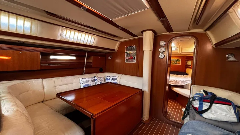 4746 Yacht Photos Pics Interior of 2006 Dufour 44 Performance yacht with cozy seating and wooden finishes.
