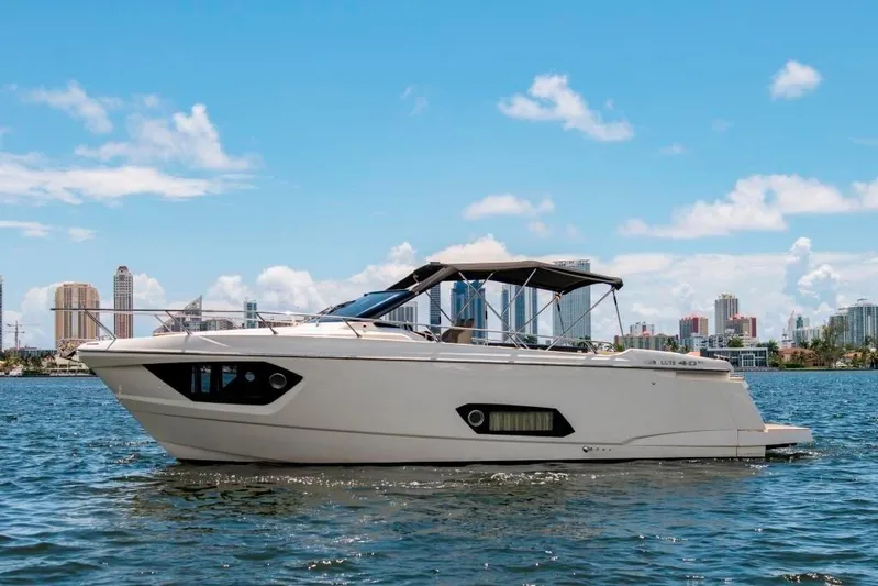 Amaretto Yacht Photos Pics 2015 Absolute 40 STL yacht cruising on a sunny day with city skyline in the background.